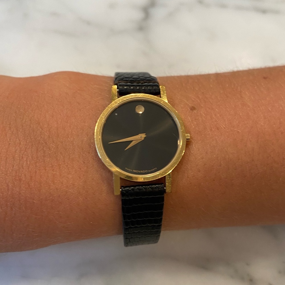 Movado women’s black and gold watch with genuine lizard leather band